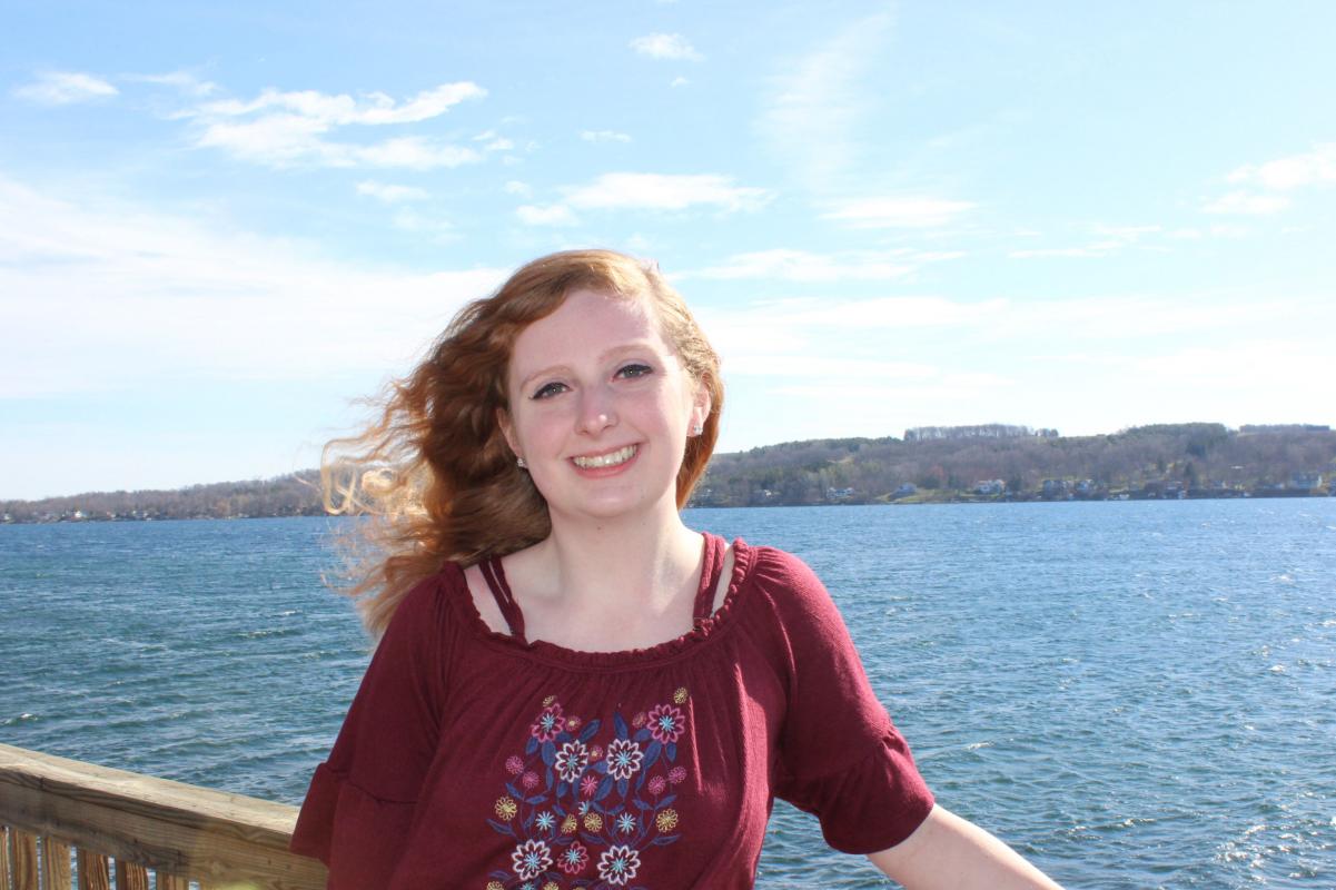 Amanda standing out by the lake