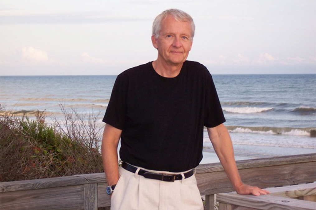 Makuck standing in front of a body of water