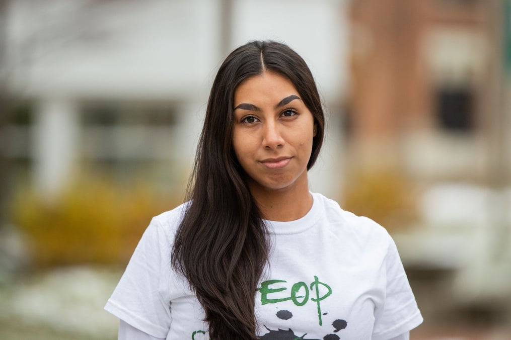 Nancy Campuzano posing in HEOP shirt outside Ball Hall