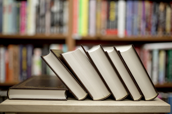 books stacked on a table in a library